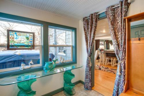 a room with a glass counter and a window at Colorful Cottage with Hot Tub - Steps to Long Lake! in Campbellsport