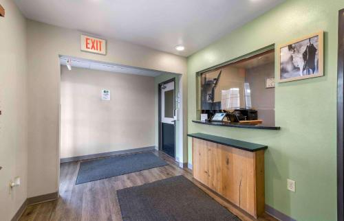 an empty hallway with an exit sign on the wall at Extended Stay America Select Suites - Lubbock - West in Lubbock