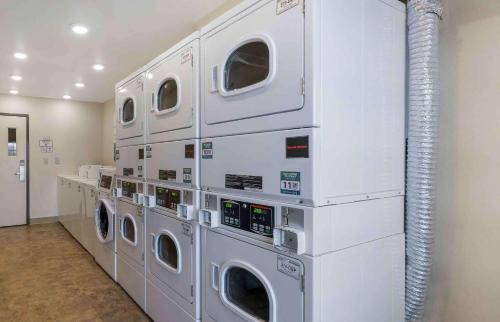 a laundry room with four washer and dryer machines at Extended Stay America Select Suites - Lubbock - West in Lubbock