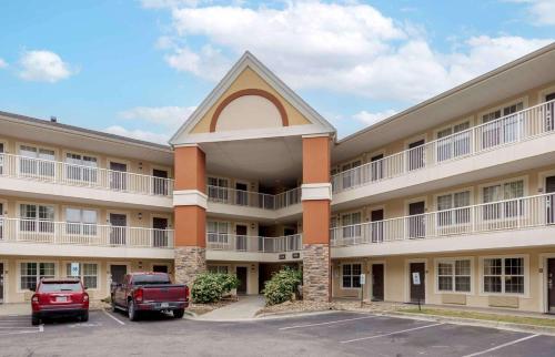 a large building with cars parked in a parking lot at Extended Stay America Select Suites - Fayetteville - Owen Dr in Fayetteville