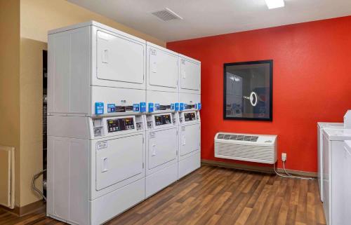 a room with white washers and a red wall at Extended Stay America Suites - Savannah - Midtown in Savannah