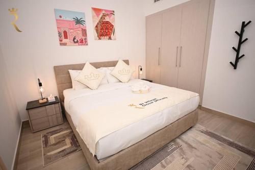 a bedroom with a large white bed in a room at Rossa Yas 1BR Haven - Chic Luxe Escape in Abu Dhabi