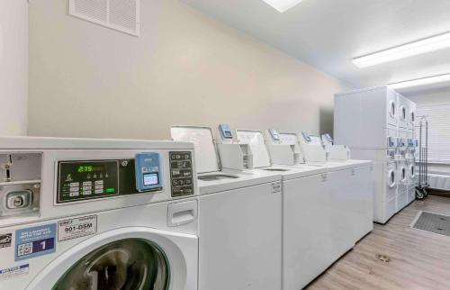 a laundry room with a row of washing machines at Studio 6 Extended Stay El Paso East TX in El Paso