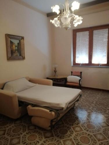 Habitación grande con cama y lámpara de araña. en Avellino camera 3 letti centralissima, en Avellino