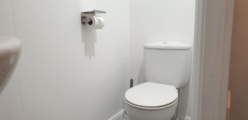 a bathroom with a white toilet in a stall at Comfort Stay Rooms in Portslade