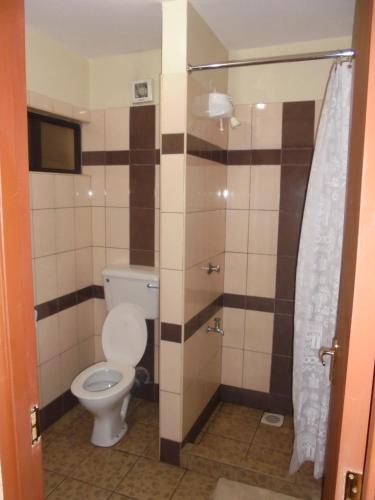 a bathroom with a toilet and a shower at Nairobi Transit Hotel in Nairobi