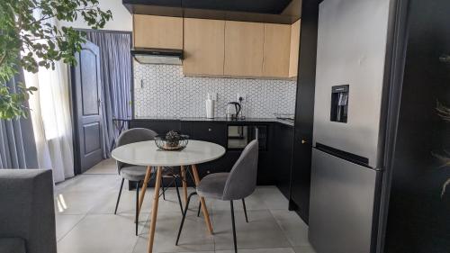 a kitchen with a table and chairs and a refrigerator at CityZen escape: blackout ready in Johannesburg