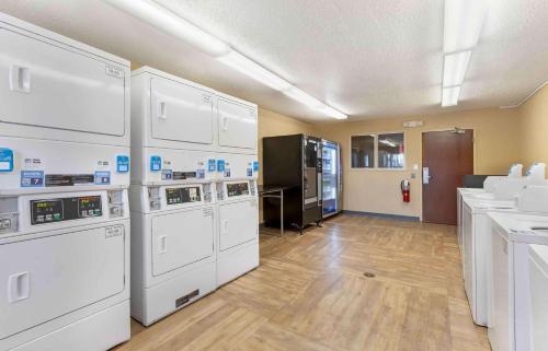 a laundry room with white washer and dryers at Extended Stay America Suites - Greenville - Airport in Greenville