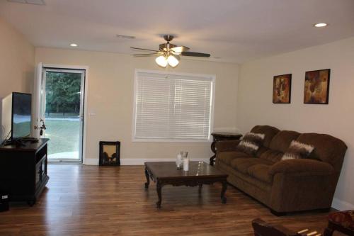 a living room with a couch and a coffee table at New Renovated 3BR/2BA home in Cobb County! in Powder Springs