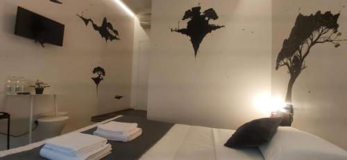 a bedroom with a bed with bats on the wall at Street Art Inn Florence in Florence