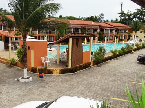 a resort with a swimming pool and a hotel at Res Village do Bosque 03 in Porto Seguro