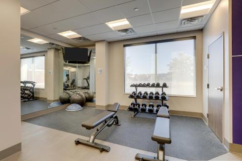 a gym with exercise equipment and a large window at Holiday Inn Express Holly Springs - Raleigh Area, an IHG Hotel in Holly Springs