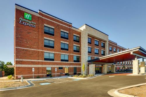 an office building with a sign on the side of it at Holiday Inn Express Holly Springs - Raleigh Area by IHG in Holly Springs