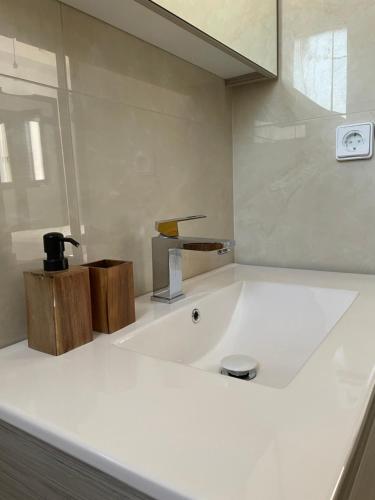 a bathroom with a bath tub with a faucet at Souvala /Aegina. Excellent location Luxury villa. in Vathí