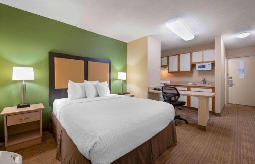 a hotel room with a bed and a kitchen at Extended Stay America Suites - Cincinnati - Fairfield in Fairfield