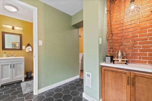 a bathroom with a sink and a brick wall at Trendy Fishtown Mid-Century Modern Inspired Home in Philadelphia