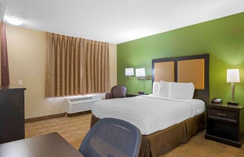 a hotel room with a large bed and a desk at Extended Stay America Suites - Columbus - Worthington in Worthington