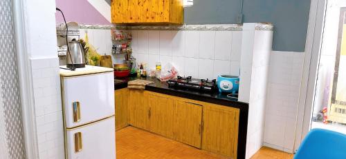 a kitchen with a white refrigerator and a counter top at Lavender House in Ấp Kim Thạch