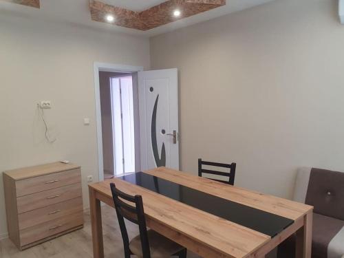 a dining room with a wooden table and chairs at Граф игнатиев луксозен апартамент с топ гледка in Yambol