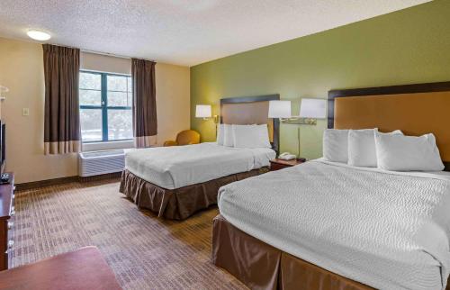 a hotel room with two beds and a window at Extended Stay America Select Suites - Orlando - Maitland - 1760 Pembrook Dr in Orlando