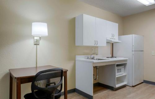 a small kitchen with a sink and a white refrigerator at Extended Stay America Suites - Orlando - Maitland - 1776 Pembrook Dr in Orlando