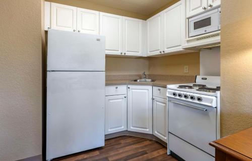 a kitchen with white appliances and a white refrigerator at Extended Stay America Suites - Orlando - Maitland - 1776 Pembrook Dr in Orlando