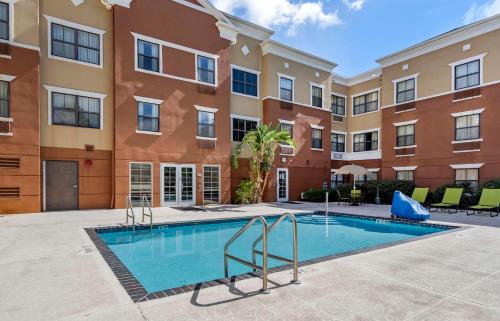 a swimming pool in front of a building at Extended Stay America Suites - Orlando - Maitland - 1776 Pembrook Dr in Orlando