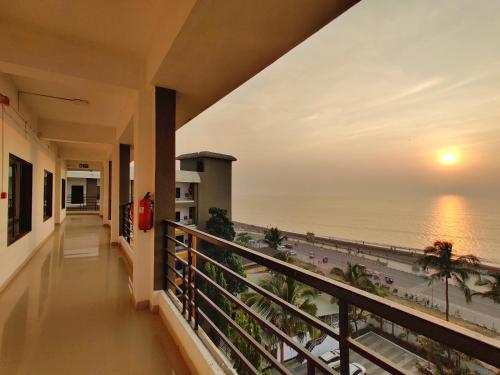 a balcony with a view of the ocean at Golden Chariot Hotel Daman in Daman