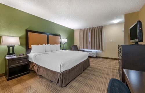 a hotel room with a large bed and a television at Extended Stay America Suites - Orlando - Orlando Theme Parks - Major Blvd in Orlando