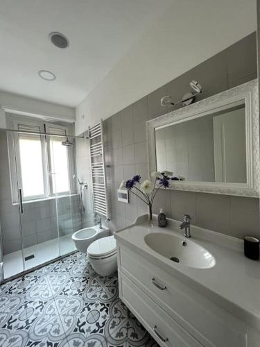 a bathroom with a sink and a toilet and a shower at Appartamento Milano centro Corso Como in Milan