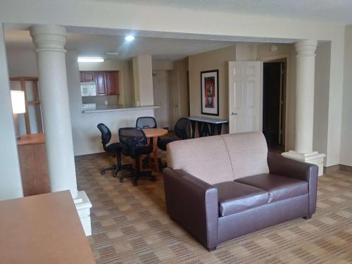 a living room with a couch and a table at Extended Stay America Suites - Jacksonville - Deerwood Park in Jacksonville