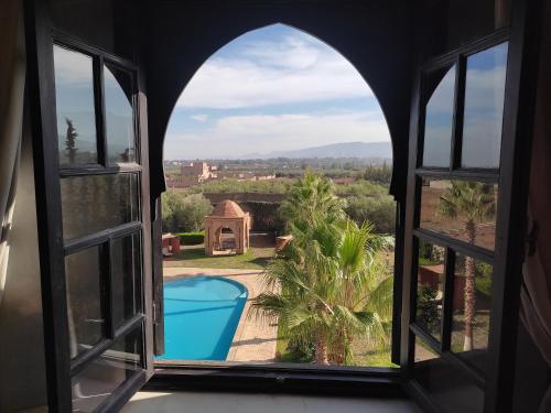 an open window with a view of a pool at Kasbah ATFEL in Ourika