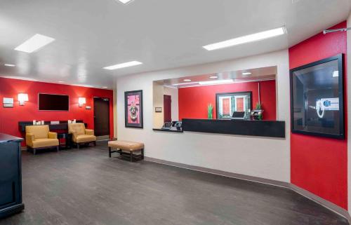 a waiting area in a hospital with red walls and a waiting room at Extended Stay America Suites - Pensacola - University Mall in Pensacola