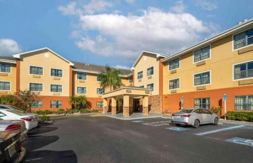 a large building with cars parked in a parking lot at Extended Stay America Suites - St Petersburg - Clearwater - Executive Dr in Clearwater