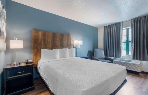 a hotel room with a bed and a chair at Extended Stay America Premier Suites - Lakeland - I-4 in Lakeland