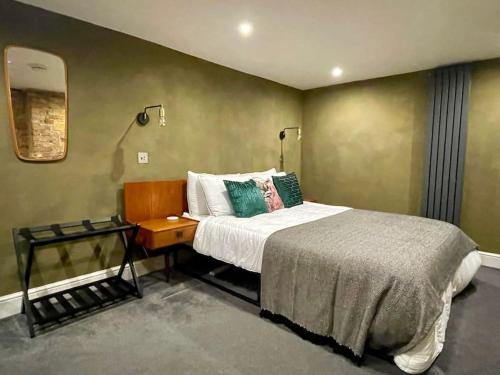 a bedroom with a bed and a side table at Exposed Brick Flat Finsbury Park in London