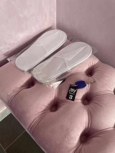 a pink couch with a price tag on it at JOY APARTMENTS Zemun,Beograd in Zemun