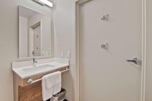 a bathroom with a sink and a mirror at Extended Stay America Suites - Miami - Airport - Blue Lagoon in Miami