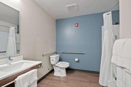 a bathroom with a white toilet and a sink at Extended Stay America Suites - Miami - Airport - Blue Lagoon in Miami