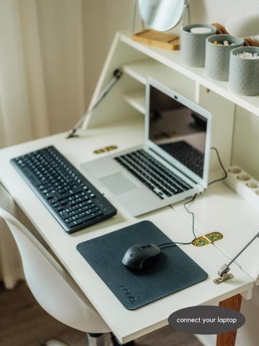 a desk with a laptop computer and a mouse on it at happyhome mitten im HARZ - direkte Wanderwege - Bachplätschern - Küche - Kinderfreundlich - Paare und Freunde in Elend