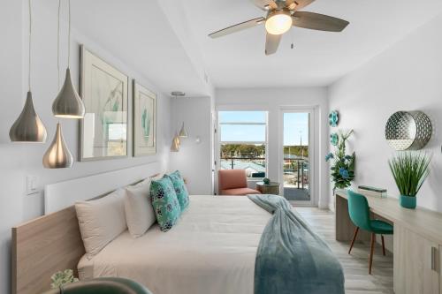 a living room with a bed and a ceiling fan at Dolphins Vacation Rental in Merritt Island