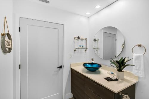 a bathroom with a sink and a mirror at Dolphins Vacation Rental in Merritt Island