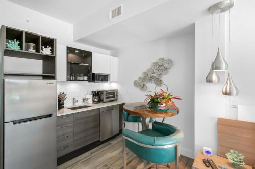 a kitchen with a table and a blue chair at Dolphins Vacation Rental in Merritt Island
