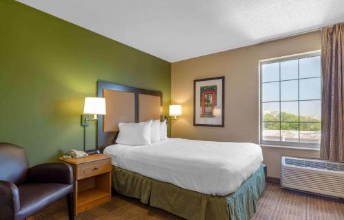 a hotel room with a bed and a window at Extended Stay America Suites - Boston - Burlington in Burlington