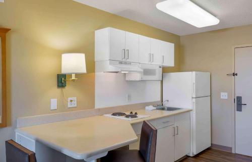 a kitchen with white cabinets and a white refrigerator at Extended Stay America Suites - Boston - Burlington in Burlington