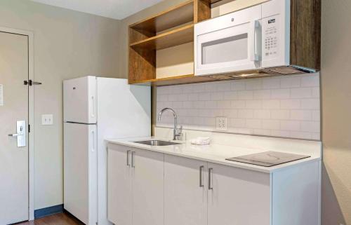a white kitchen with a sink and a refrigerator at Extended Stay America Suites - Boston - Burlington in Burlington