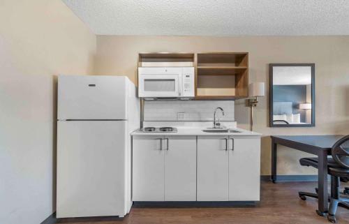 a kitchen with a white refrigerator and a microwave at Extended Stay America Suites - Boston - Burlington in Burlington