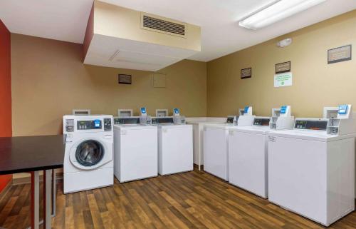 a laundry room with four washing machines and a washer and dryer at Extended Stay America Suites - Boston - Burlington in Burlington