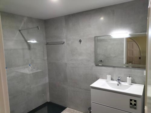 a bathroom with a sink and a mirror at Shearwaternest Apartment AL in Funchal