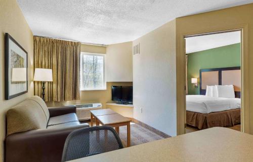 ein Hotelzimmer mit einem Bett und einem Wohnzimmer in der Unterkunft Extended Stay America Suites - Boston - Peabody in Peabody